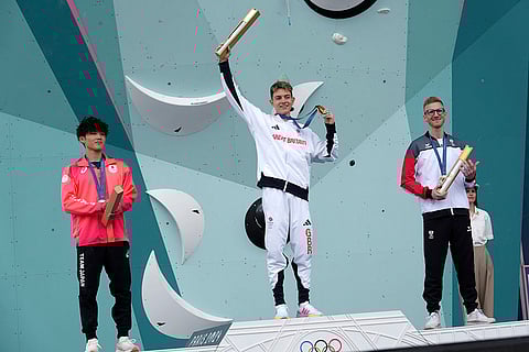 Men's boulder and lead final: Gold medallist Toby Roberts of Great Britain, center, silver medallist Sorato Anraku of Japan, left, and bronze medallist Jakob Schubert of Austria